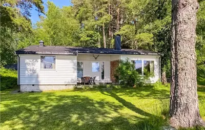 a small white house in the middle of a yard at 4 Bedroom Beach Front Home In Skodje in Skodje