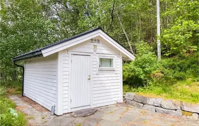 a small white shed with a window in it at 4 Bedroom Beach Front Home In Skodje in Skodje