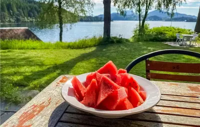 a bowl of watermelon sitting on a wooden table at 4 Bedroom Beach Front Home In Skodje in Skodje