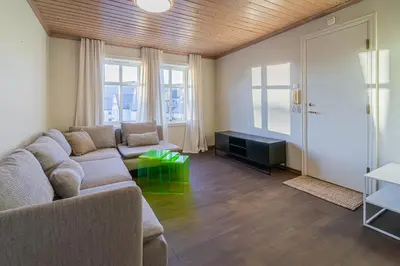 a living room with a couch and a table at Charming and bright apartment in Ålesund city in Ålesund
