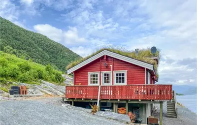 a red house with grass on the roof at Nice Home In Selje With Wifi in Stokke
