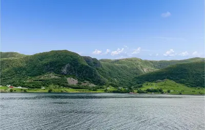 a large body of water with mountains in the background at Nice Home In Selje With Wifi in Stokke