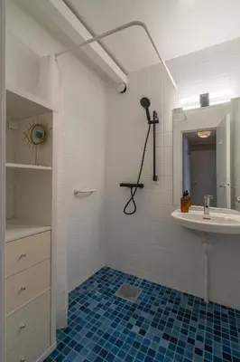 a white bathroom with a sink and a mirror at Fjord view apartment in Ålesund with free parking in Ålesund