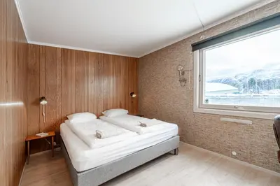 a bedroom with a bed and a large window at Fjord view apartment in Ålesund with free parking in Ålesund