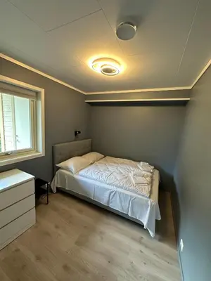 a bedroom with a bed in the corner of a room at Loen Panorama in Stryn