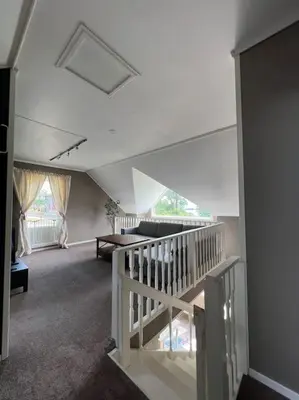 a living room with a staircase in a house at Moldegaard Farmhouse - Apartment C in Moldegard