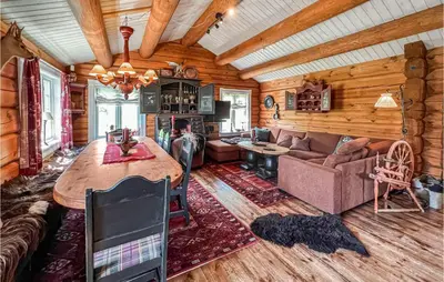 a living room with a couch and a table in a cabin at Nice Home In Svingvoll in Svingvoll
