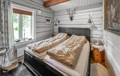 two beds in a room with white walls at Nice Home In Svingvoll in Svingvoll