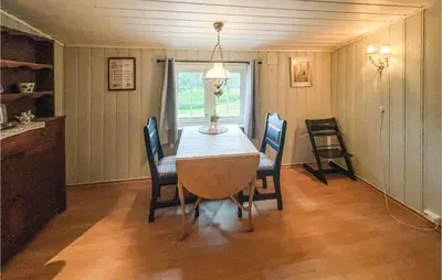 a dining room with a table and chairs at Nice Home In Sagstua With Lake View in Linstad