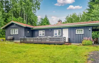a small house with a large bench in the yard at Nice Home In Sagstua With Lake View in Linstad