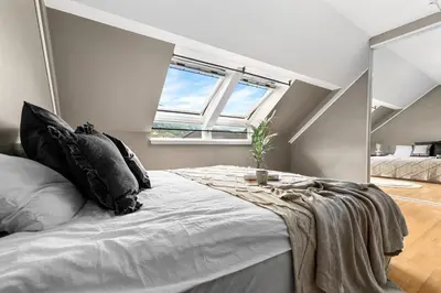 a bedroom with a large bed and a window at Beautiful apartment with 3 bedrooms in Sogndal