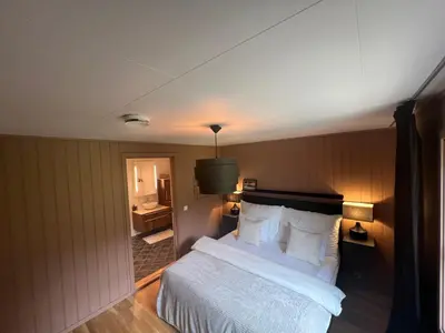 a bedroom with a bed and a bathroom at Røstad Apartment - with Kitchen and Free Parking in Trondheim