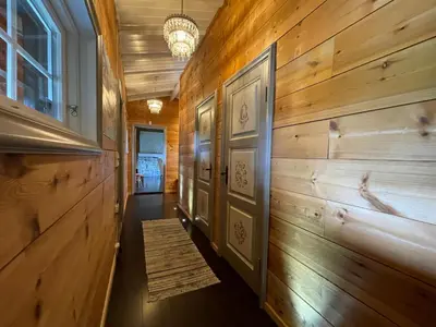 a hallway with wood paneled walls and a hallway with a door at Baybu - cabin close Geilo Skisenter and the center of Geilo in Geilo