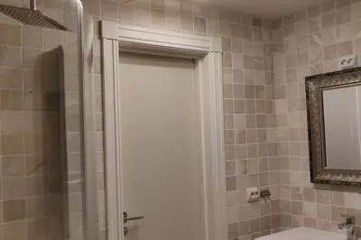 a bathroom with a shower and a sink and a mirror at Hus med utsikt på leira . 4 sengeplasser. in Leira