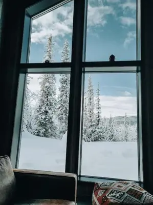 a window with a view of a snow covered forest at Peaceful Oasis. Panoramic forest- & mountain view. Sauna. in Beitostøl