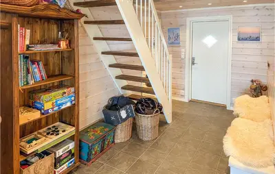 a room with a book shelf and a staircase at 5 Bedroom Gorgeous Home In Sjusjøen in Sjusjøen