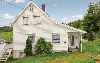 a white house on top of a hill at Amazing Home In Dale I Sunnfjord in Gjølanger