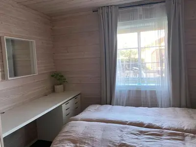 a bedroom with a bed and a window with a mirror at Cosy and well-equipped apartment with free parking in Trondheim