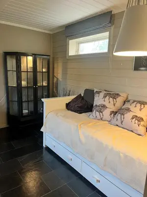 a bed in a room with a window at Cosy and well-equipped apartment with free parking in Trondheim
