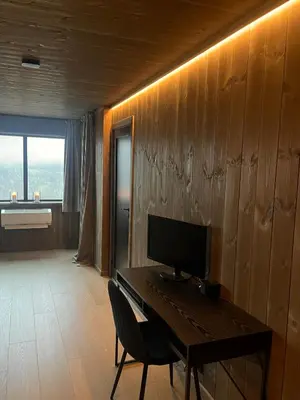 a room with a desk with a computer on it at Sogndal Chalet in Sogndal
