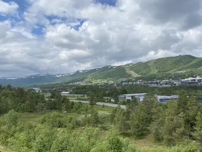 a view of a town with mountains in the background at Spacious and beautiful apartment in Geilo, mountain retreat with view! in Geilo