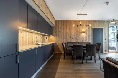 a kitchen and dining room with a table and chairs at Leiligheter på Fyri Resort - Hemsedal in Hemsedal