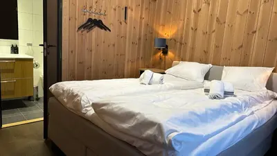 a large bed with white sheets and pillows on it at Leiligheter på Fyri Resort - Hemsedal in Hemsedal