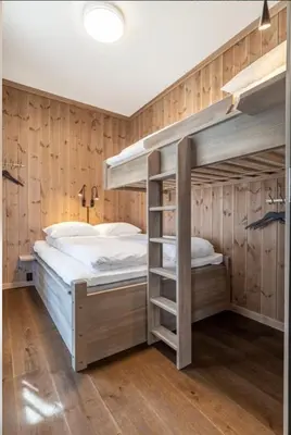 two bunk beds in a room with wooden walls at Leiligheter på Fyri Resort - Hemsedal in Hemsedal