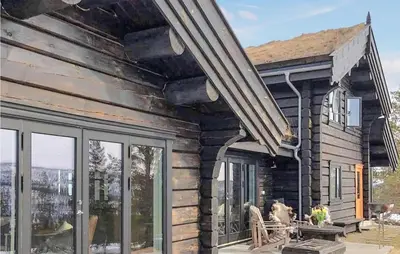 a log house with a porch with sliding glass doors at 5 Bedroom Gorgeous Home In Tynset in Tynset