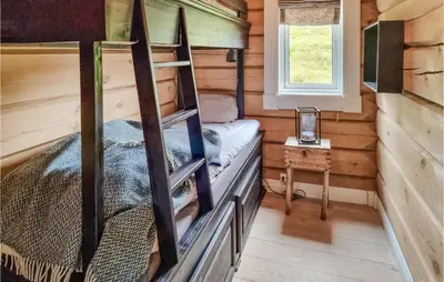 a bedroom with a bunk bed in a log cabin at 5 Bedroom Gorgeous Home In Tynset in Tynset