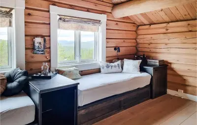 a room with a bed in a log cabin at 5 Bedroom Gorgeous Home In Tynset in Tynset