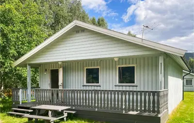 a green house with a picnic table in front of it at 2 Bedroom Stunning Home In Dovre in Dovre