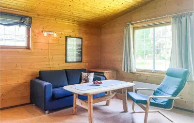 a living room with a couch and a table and chairs at Gorgeous Home In Dovre With Wifi in Dovre