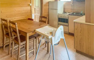 a kitchen with a wooden table and a refrigerator at Gorgeous Home In Dovre With Wifi in Dovre