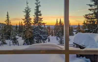 a view from a window of a snow covered yard at Beautiful Home In Sjusjøen With Sauna in Sjusjøen