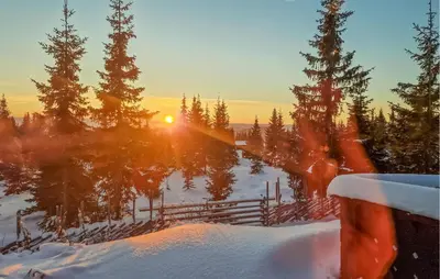a winter sunset over a lake with snow and trees at Beautiful Home In Sjusjøen With Sauna in Sjusjøen