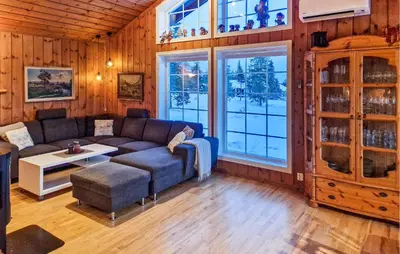a living room with a couch and a table at Beautiful Home In Sjusjøen With Sauna in Sjusjøen