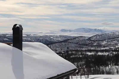 a snowboard sitting on top of a snow covered mountain at Veslestølen - Ålhytte with amazing view, 1000 meter in Ål