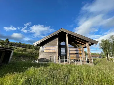 an old cabin in a field of tall grass at Veslestølen - Ålhytte with amazing view, 1000 meter in Ål