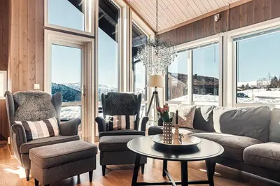 a living room with a couch and chairs and a table at Harevadet 211 in Hornindal
