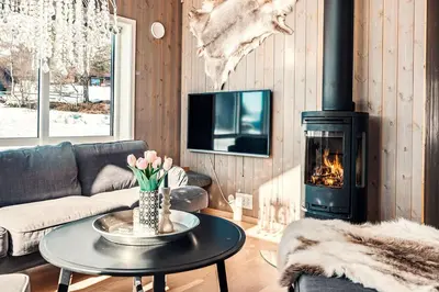 a living room with a couch and a fireplace at Harevadet 211 in Hornindal