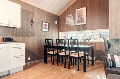 a kitchen with a dining room table and chairs at Harevadet 211 in Hornindal