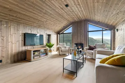 a living room with a couch and a tv at Hodlekvevegen 307 in Sogndal