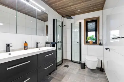 a bathroom with a sink and a shower and a toilet at Hodlekvevegen 307 in Sogndal