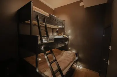 a bunk bed with a ladder in a room at Elegant apartment in Trysil Alpine Lodge in Trysil
