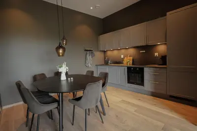 a kitchen with a dining room table and chairs at Elegant apartment in Trysil Alpine Lodge in Trysil