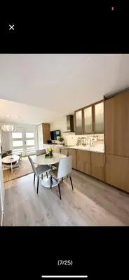 a living room with a table and a kitchen at Bjorli Apartment with everything, 150m from ski lift in Bjorli