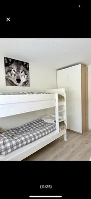 a white bunk bed with a picture of a wolf at Bjorli Apartment with everything, 150m from ski lift in Bjorli