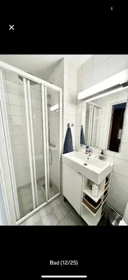 a white bathroom with a shower and a sink at Bjorli Apartment with everything, 150m from ski lift in Bjorli
