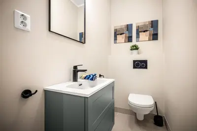 a bathroom with a sink and a toilet at Corner Apartments in Bergen